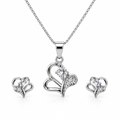 Silver-tone curved heart necklace and matching studs on white