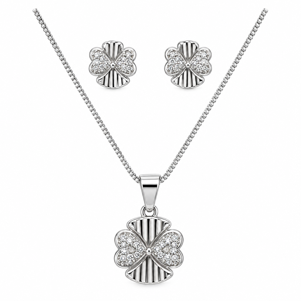 Silver-tone four-petal pendant necklace with matching stud earrings against white
