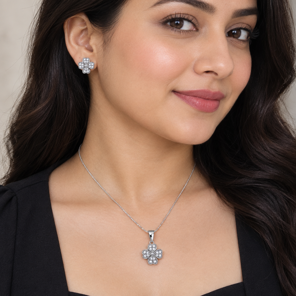 Model in dark outfit wearing floral pendant necklace and matching stud earrings