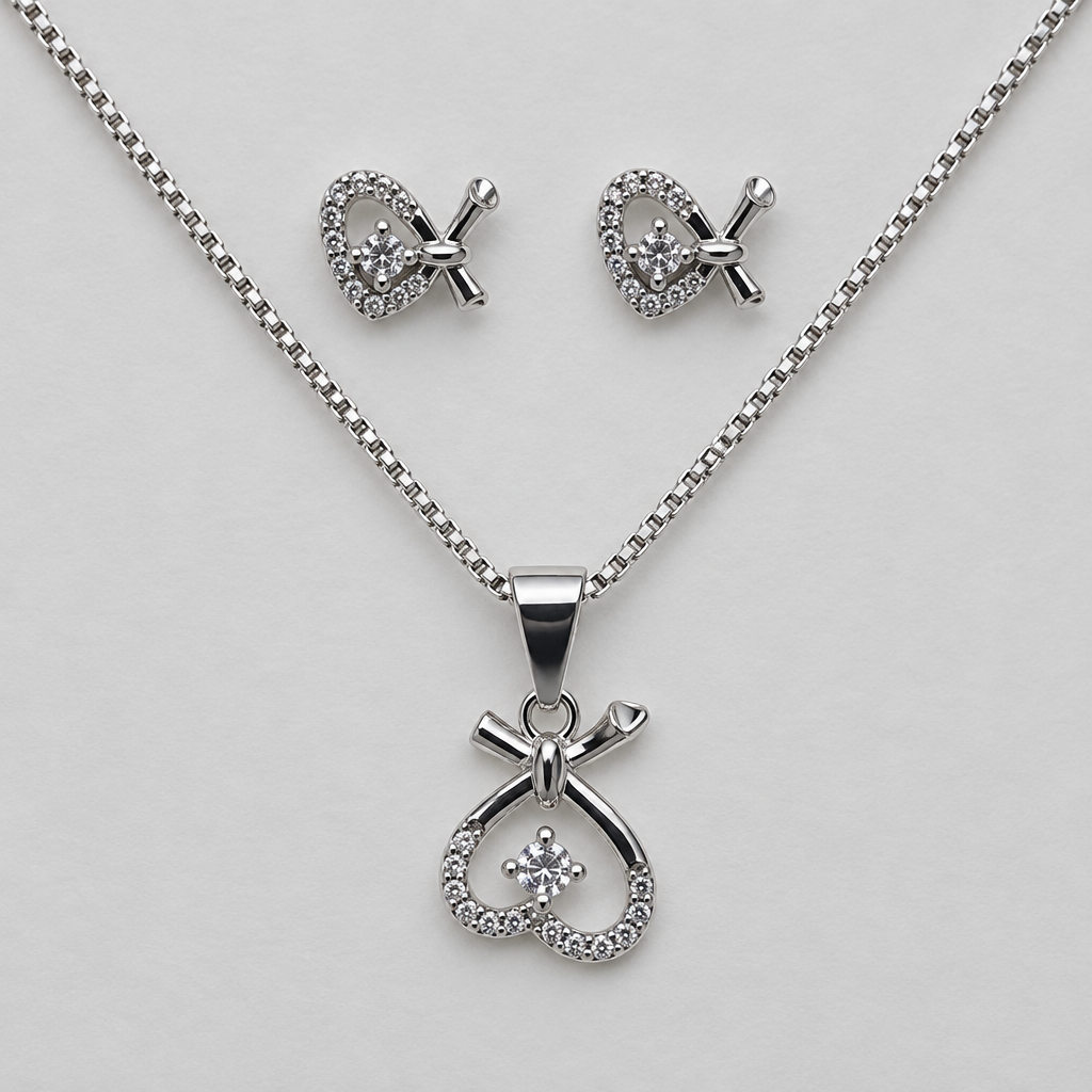 Close view of heart-loop pendant and matching silver-tone stud earrings