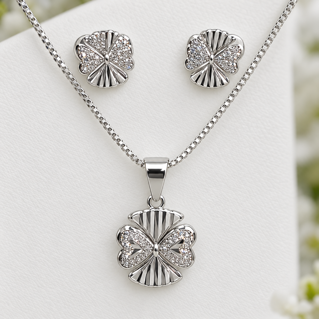 Close view of matching silver-tone pendant and stud earrings with ridged details